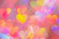 blurred heart shaped holographic bokeh lights background