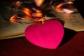 Blurred heart with space for text , book and garland, in dark settings. happy love and cozy home concept