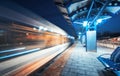 Blurred high speed train on the railway station at night