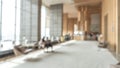 Blurred hotel or office building lobby blur background interior view toward reception hall, modern luxury white room Royalty Free Stock Photo