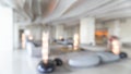 Blurred hotel or office building lobby blur background interior view toward reception hall, modern luxury white room space Royalty Free Stock Photo