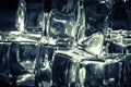 Blurred ice cubes covered with liquid isolated on dark background