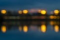 Blurred image for background. Night traffic and lanterns lights with reflection in water Royalty Free Stock Photo