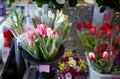 Blurred image of bouquet of fresh tulips in flower shop. Lot of multicolored tulips bouquets Royalty Free Stock Photo