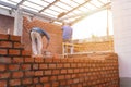 Blurred image of Bricklayer worker installing brick masonry on exterior wall with trowel putty knife on construction site