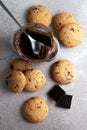 Blurred image of cookies and a jar of chocolate paste and a spoon on a gray table. Snack concept Royalty Free Stock Photo