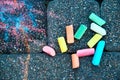 Blurred image drawing on the pavement next to colored chalk. The concept of a happy childhood