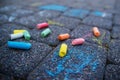 Blurred image drawing on the pavement next to colored chalk. The concept of a happy childhood. No focus