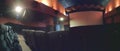 Blurred image of empty theater or cinema hall with rows of seats or chairs, screen and dim lighting, defocused Royalty Free Stock Photo