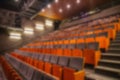 Blurred image of empty theatre or cinema auditorium hall with rows of seats or chairs, defocused Royalty Free Stock Photo