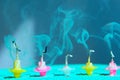 Blurred image of fading candles, blurry smoke, blue background. Holidays, Birthday concept. Small colorful melted candles.