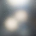 A blurred image featuring soft, diffuse light sources against a grayish background. The surface Royalty Free Stock Photo