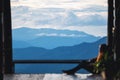 A female traveler sitting and looking at a beautiful mountain and nature view before sunset Royalty Free Stock Photo