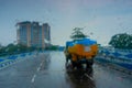 Blurred image, Kolkata, West Bengal, India. Image shot through raindrops falling on wet glass, abstract blurs of traffic - Royalty Free Stock Photo