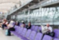 Blurred image of a man read newspaper while waiting the flight i