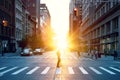 Blurred image of a man walking across the street in New York City with the bright light of sunset shining through the buildings