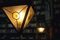 Blurred image, many old books on the bookshelf in the library, a large triangular lamp Royalty Free Stock Photo