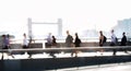 Blurred image of office workers crossing the London bridge in early morning on the way to the City of London, England, UK