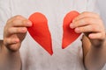 Blurred image of paper torn heart in hands on light background Royalty Free Stock Photo