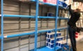 Blurred image of people hoarding products in the supermarket. Supermarket shelves are almost empty due to Coronavirus Royalty Free Stock Photo