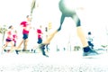 Blurred image of people running in massive marathon on a sunny summer day.