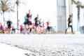 Blurred image of people running in massive marathon on a sunny summer day.