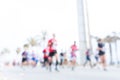 Blurred image of people running in massive marathon on a sunny summer day.