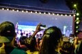 Blurred image - People takes a picture with his smartphone in a live Pong Lang performances in the night at Bangkok, Thailand