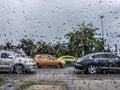 Blurred image - Rain drops stuck the car window, Blurred car on the road at Thailand in rainy day, The car caught on a rainy day Royalty Free Stock Photo