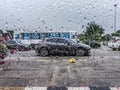 Blurred Image - Rainy season - Rain drops stuck the car window, Blurred car on the road at Thailand in rainy day, The car caught Royalty Free Stock Photo