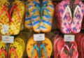 Blurred Image of the Row of Vivid Color Beach Sandals Hanging on the Rack