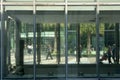 Blurred image of A shopper walking past a shopping store centre
