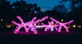 Blurred image shows two installations of bright pink lights resembling spider-like Royalty Free Stock Photo
