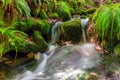 Blurred image of a small river waterfall close-up long exposure Royalty Free Stock Photo