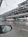 Blurred image, street view on rainy day, bokeh on rearview mirror