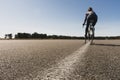Blurred image of a woman cyclist on a sunny summer day.