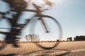 Blurred image of a woman cyclist on a sunny summer day.