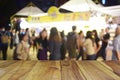 Blurred image wood table and food at night festival with bokeh b