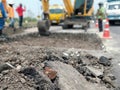 excavation of roads repaired using heavy machinery and human labor Royalty Free Stock Photo