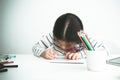 Blurred images of A 6 year old Asian girl are concentrating on making card