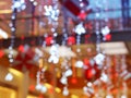 Blurred interior with bokeh: shopping center festively lit and decorated with shiny garlands for holidays, Christmas a Royalty Free Stock Photo