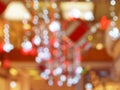 Blurred interior with bokeh: shopping center festively lit and decorated with shiny garlands for holidays, Christmas a Royalty Free Stock Photo