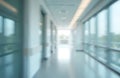 Blurred interior of modern hospital corridor. Abstract motion creates dynamic, airy feel. Clean hall with doors, windows Royalty Free Stock Photo