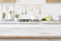 Blurred kitchen background with wooden table top for in front Royalty Free Stock Photo