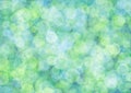Blurred light green background with blue circle sparkling lights. Shiny olive glittery bokeh of christmas garland Royalty Free Stock Photo