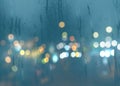 Blurred light at rainy season evening windows with rain drops  lamp light background abstract template Royalty Free Stock Photo