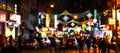 Blurred lights of a street scene with people and cars in Manhattan New York City at night Royalty Free Stock Photo