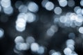 Blurred lights dark gray blue background. Abstract bokeh with soft light. Shiny festive christmas texture Royalty Free Stock Photo