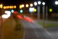 blurred lights of the night city with a view of the roadway. multicolored lights of city lanterns in out of focus. bright abstract Royalty Free Stock Photo