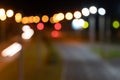 blurred lights of the night city with a view of the roadway. multicolored lights of city lanterns in out of focus. bright abstract Royalty Free Stock Photo